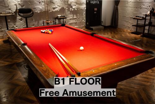a snooker table with a red cloth in a room at BaliAn Resort Chiba-Chuo in Chiba
