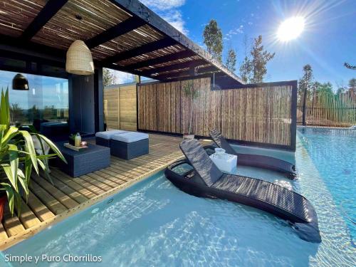 a swimming pool with a raft in the water at Simple y Puro Chorrillos in Navidad