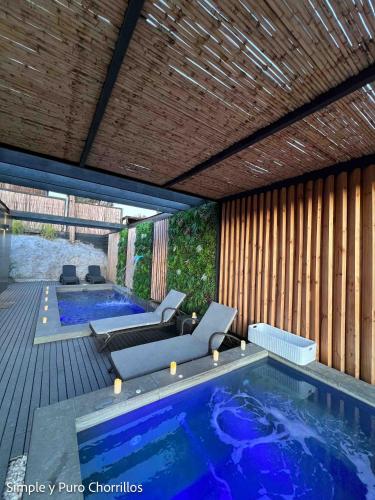 a large swimming pool in a house with a deck at Simple y Puro Chorrillos in Navidad