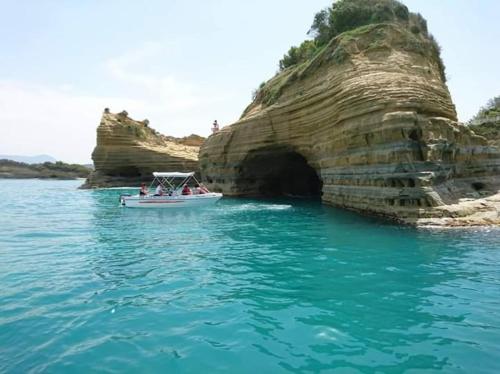 a group of people in a boat in the water at Natural Blue Suites-Canal d'Amour Retreat in Sidari