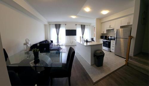 a kitchen and living room with a glass table in it at Cozy Home Close to Blue Mountain and Collingwood in Shelburne