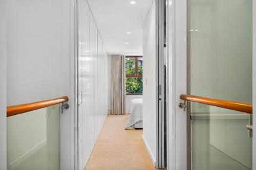 a hallway with a door leading to a bedroom at Stylish Fully Renovated Luxe 3BR, 2BA Balmain Terrace near Parks, Ferry, Cafes & Pubs in Sydney