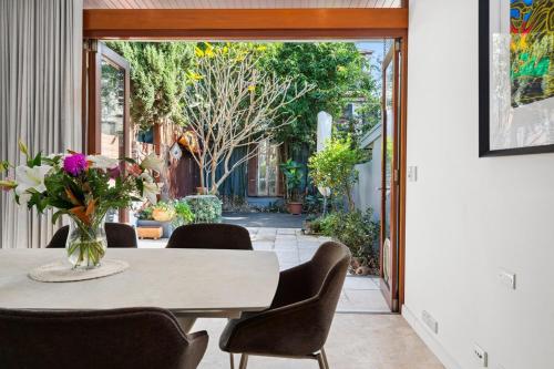 a dining room with a table and chairs at Stylish Fully Renovated Luxe 3BR, 2BA Balmain Terrace near Parks, Ferry, Cafes & Pubs in Sydney