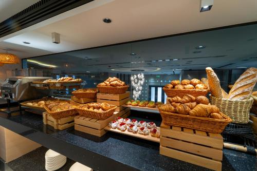 a bakery with lots of different types of bread at Hill Top Hotel in Aqaba