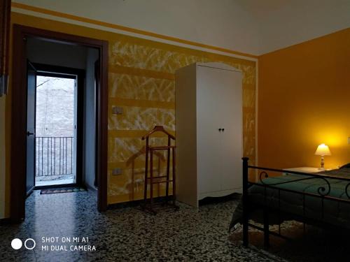 a room with a bedroom with a bed and a window at Guest House Tiria in Bosa