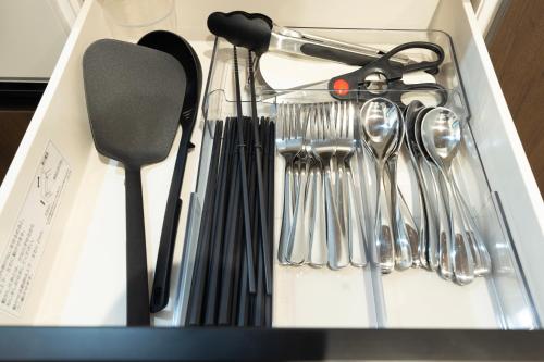 a drawer filled with utensils in a box at 新築戸建別荘 M&Z house2 in Fukuoka