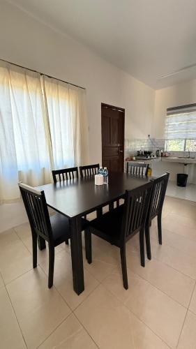 a dining room table and chairs in a room at MP Homestay Kota Marudu in Gua Sai