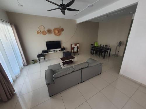 a living room with a couch and a ceiling fan at 74 pangkorocean villa88 in Kampong Sungai Udang