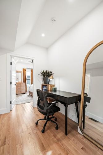 an office with a black desk and a chair at Forest Hill condos -Boston in Boston