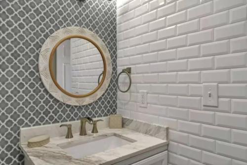 a bathroom with a sink and a mirror at Salty Beach Getaway! in Destin