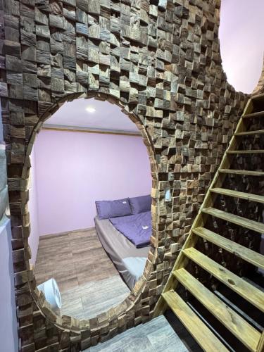 a room with a bed and a brick wall at 海的那一間Hostel By The Sea in Green Island