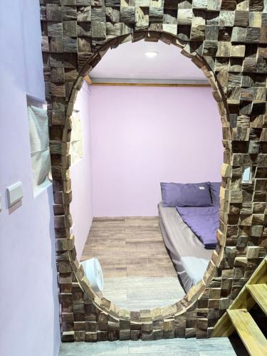 a room with a bed in a brick wall at 海的那一間Hostel By The Sea in Green Island
