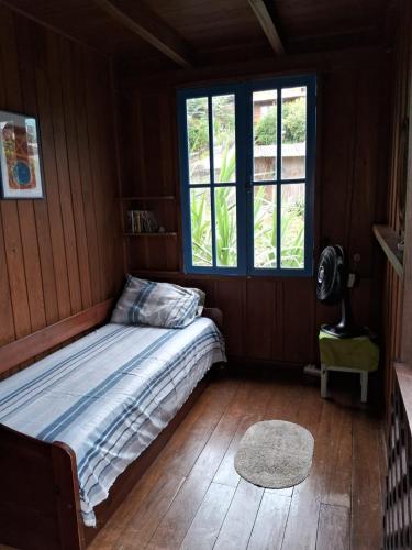 a bedroom with a bed and a window at Solar da Lagoa in Florianópolis