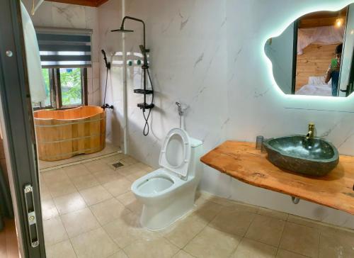 a bathroom with a toilet and a sink at A Thía homestay in Diện Biên Phủ