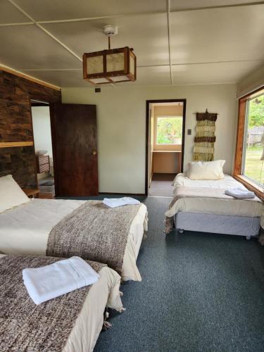 a bedroom with three beds in a room at Casa Bordemar in Castro