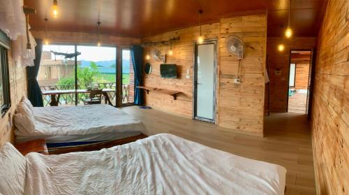 a room with two beds and a balcony with a view at A Thía homestay in Diện Biên Phủ