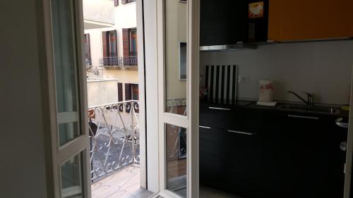 a kitchen with a sliding glass door to a balcony at BSuites Apartment in Padova
