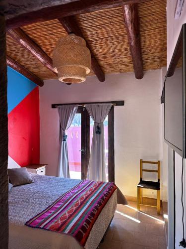 a bedroom with a large bed and a window at Aparthotel Ruta 52 in Purmamarca