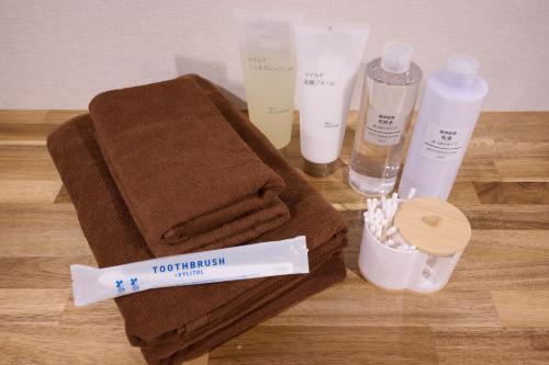 a table with towels and other products on it at Blossom House Shibuya in Tokyo