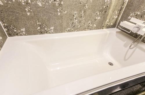 a white bathroom sink with a camera on it at Gwangju Yeogijoa Hotel in Gwangju