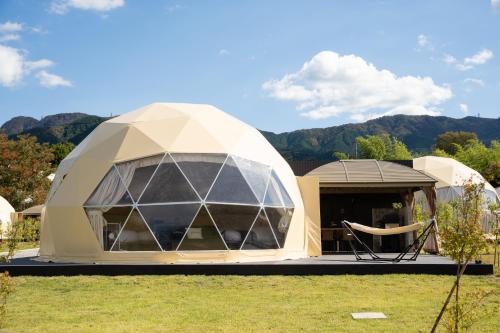 a dome house in a field of grass at Relam Glamping Resort Gotemba in Gotemba