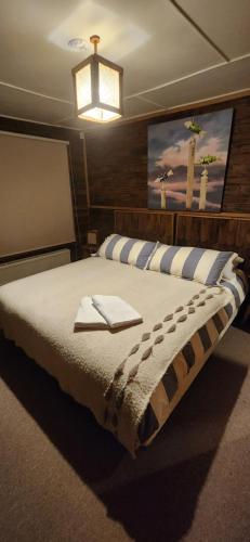 a bedroom with a large bed with a light above it at Casa Bordemar in Castro