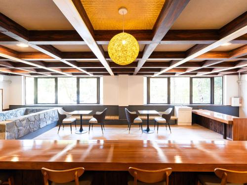 a large dining room with tables and chairs at ホテルオアシスガーデン in Obita