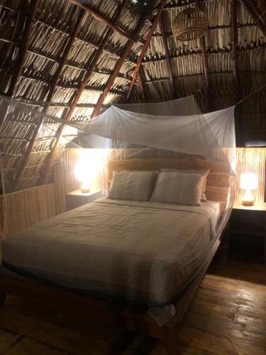 Postel nebo postele na pokoji v ubytování Itsalifestyle Jungle Cabana