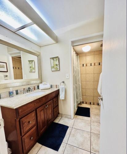 a bathroom with a sink and a mirror at Luana Kai C104 condo in Kihei