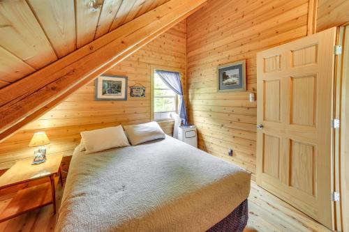 a bedroom with a bed in a wooden cabin at UP Badger Lodge BnB-Loft Family in Wetmore