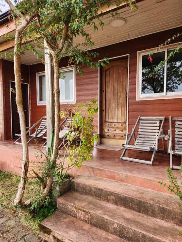 a house with two chairs and a porch with a door at Casa Bordemar in Castro