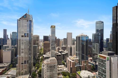 an aerial view of a city with tall buildings at Premier Tower - Modern CBD Apt 45th Floor home in Melbourne