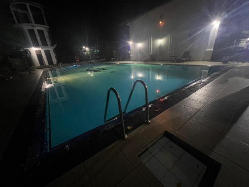 an empty swimming pool at night with lights at Hotel Sobana Lake front in Udawalawe