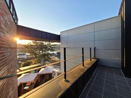 a balcony with a view of a building at Gyeongju Art Hill Family Group Pet-Friendly Pension in Gyeongju