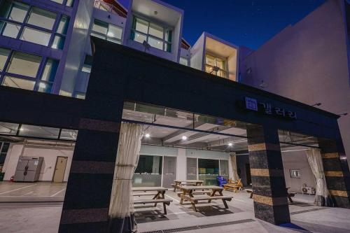 a building with picnic tables in front of it at Bada 52 Pension in Mioji