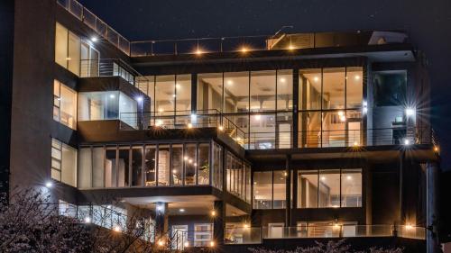 a large building with many windows at night at Geoje Hinoki Haesoojjim Resort in Geoje 