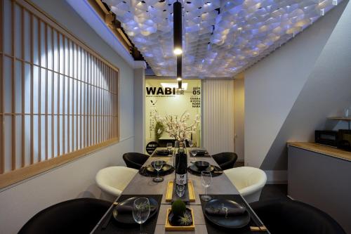 a dining room with a long table and chairs at JAPAVISTA Wabi in Osaka