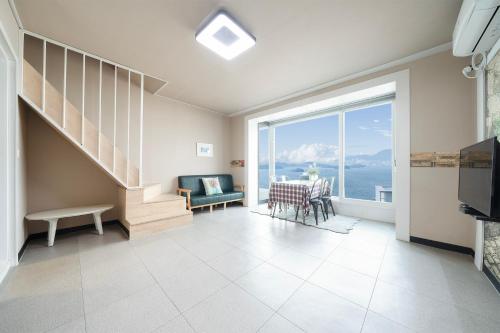 a living room with a view of the ocean at Yeosu Flower Day Ocean View Spa Couple Family Pension in Yeosu