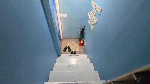 a hallway with stairs leading up to a room at Daegu Glens Guesthouse in Daegu