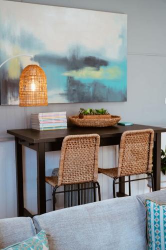 a dining room table with two chairs and a table at Farm Stay & Private Beach at Pear Tree Cottage in Middleton