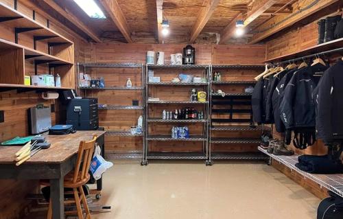 a room with a desk in a room with wooden walls at UP Badger Den in Wetmore