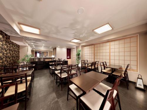 a dining room with wooden tables and chairs at Marutamachi Crystal Hotel - Vacation STAY 05336v in Kyoto