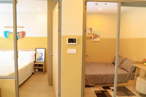 a room with a bedroom with a bed and a mirror at Gạo's Homestay - The Song in Vung Tau