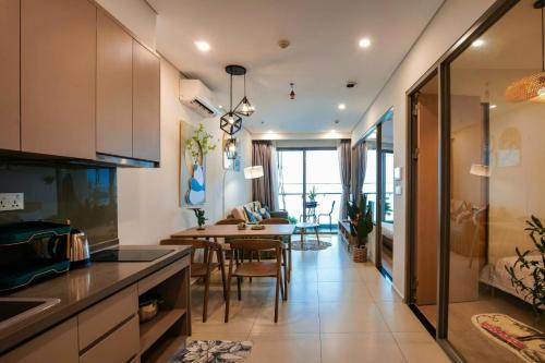 a kitchen with a table and a dining room at Gạo's Homestay - The Song in Vung Tau