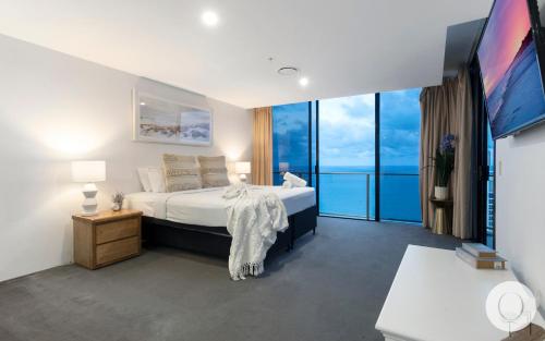 a bedroom with a large bed and a large window at 5 Bedroom Executive Sub Penthouse in the heart of Surfers with full ocean views - Sleeps 12 - Circle on Cavill AMAZING!! in Gold Coast