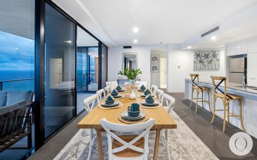 a dining room and kitchen with a table and chairs at 5 Bedroom Executive Sub Penthouse in the heart of Surfers with full ocean views - Sleeps 12 - Circle on Cavill AMAZING!! in Gold Coast