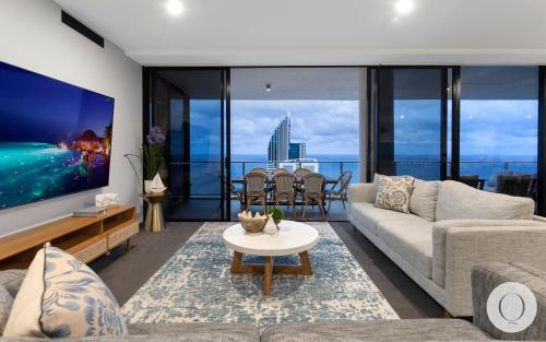 a living room with a couch and a tv at 5 Bedroom Executive Sub Penthouse in the heart of Surfers with full ocean views - Sleeps 12 - Circle on Cavill AMAZING!! in Gold Coast