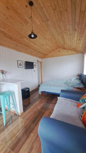 a room with a bed and a table in it at Tiny House Aeropuerto el Tepual in Puerto Montt
