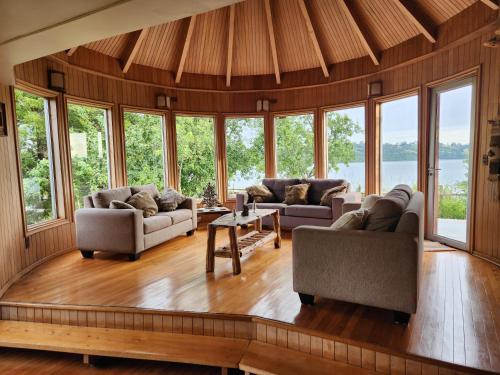 a large living room with couches and windows at Casa Bordemar in Castro