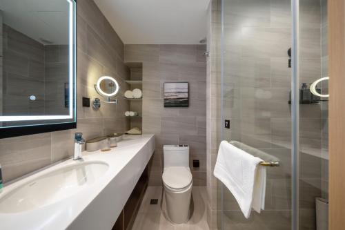 a bathroom with a sink and a toilet and a shower at Atour Hotel Shanghai Wujiaochang West Yingao Road Station in Shanghai